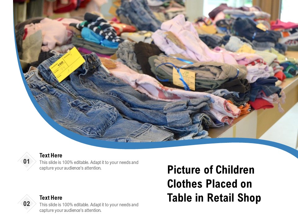 Picture Of Children Clothes Placed On Table In Retail Shop Ppt PowerPoint Presentation Slides Images PDF